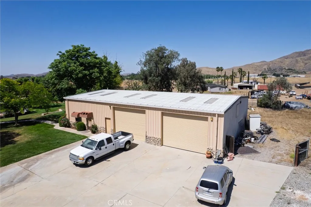 Separate 3,750 sq ft steel building, 1,075 sq ft ADU.  ADU Access is the door on the very left below the awning.
