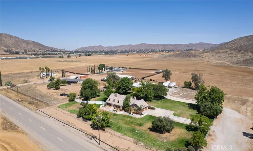 Aerial view with surrounding hills.