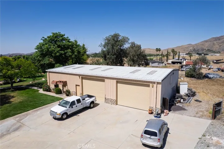 Separate 3,750 sq ft steel building, 1,075 sq ft ADU.  ADU Access is the door on the very left below the awning.