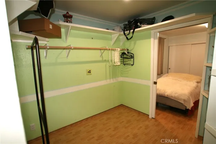 Walk in closet to primary bedroom