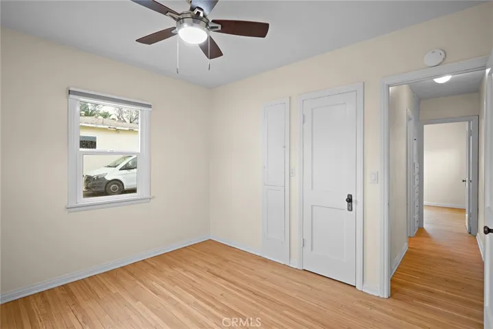 Bedroom 2 with hardwood floors.
