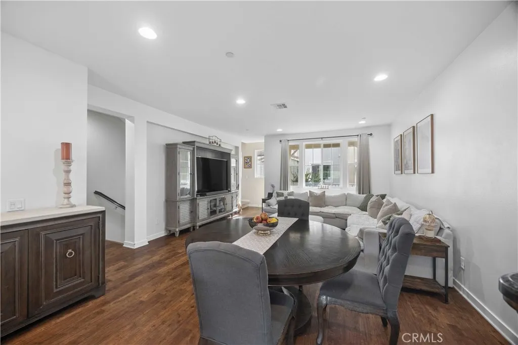 Second-level great room featuring expansive open-concept layout, wood laminate floors and a stunning view straight through to the gourmet kitchen.