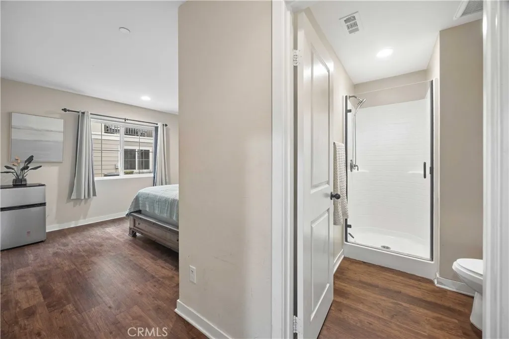 Ground-level bedroom and adjacent full bath ideal for guests, in-laws, or a private home office suite.