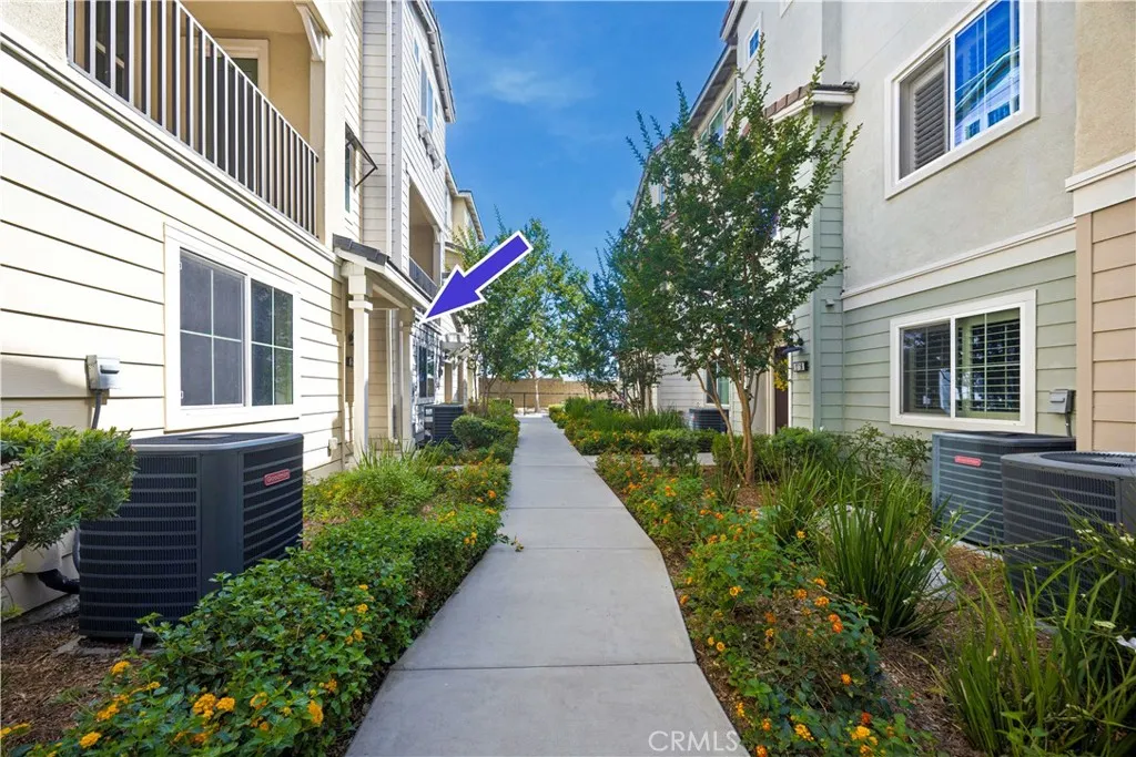 Beautifully landscaped community walkway leading to your front door with colorful blooms year round.