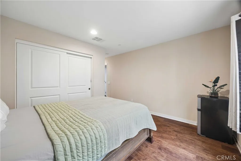 Entry-level bedroom featuring sliding closet doors & en-suite bathroom access