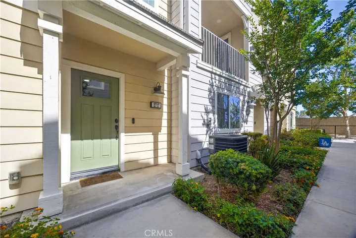 Charming entry with sage green front door, covered porch & Ring doorbell. First impressions done right.