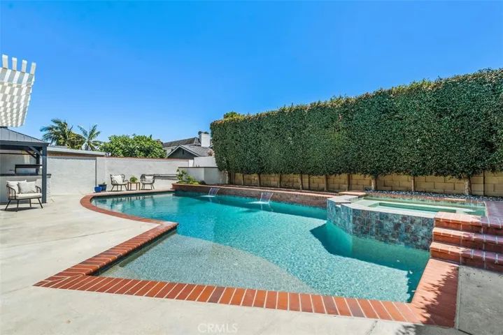 Summertime fun in the sparkling saltwater pool with Baja step great for pool lounging!