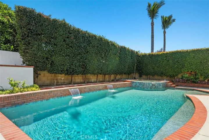 How about a few laps in this refreshing Pebble Tec saltwater pool ... showcasing 2 waterfalls enhancing the outdoor ambience