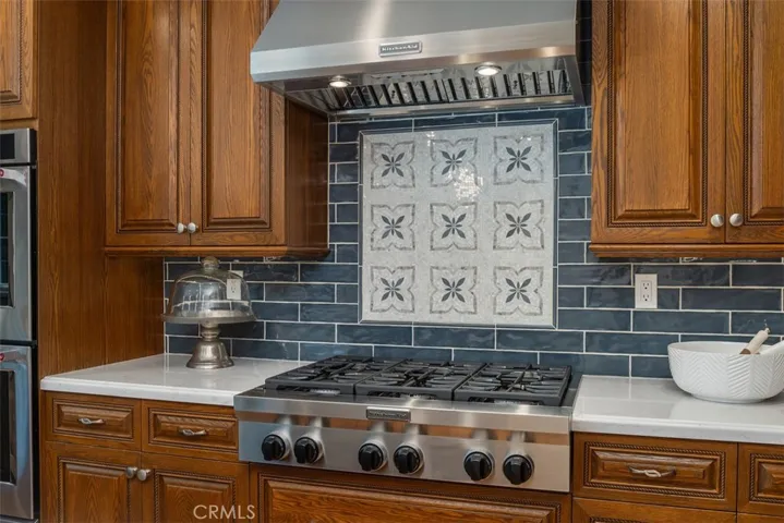Appointed with a 6 burner gas cooktop and stainless steel vent, truly a chef's delight for those who love to cook!