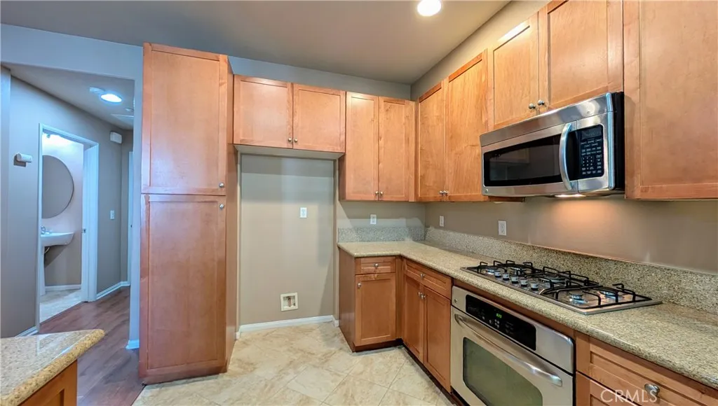 Kitchen view towards 1/2 bath and garage access