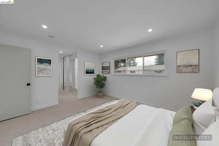 Neutral-toned bedroom featuring recessed lighting, a single horizontal window, and plush carpeting