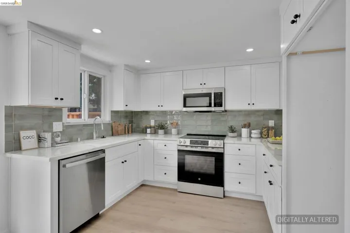 Modern kitchen featuring white shaker cabinetry, quartz countertops, a subway tile backsplash, recessed lighting, and stainless steel appliances