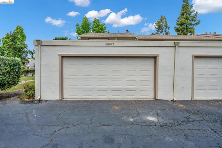 Attached single-car garage featuring a paneled door