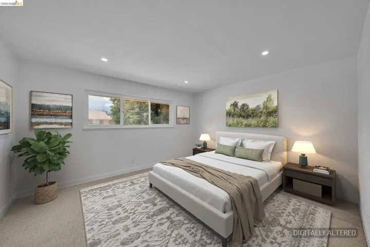 Light gray walls complement the carpeted flooring and recessed ceiling lights
