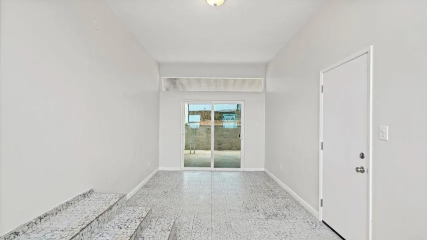 From kitchen door to closed in Patio to garage.