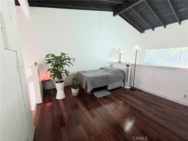 Loft Bedroom with Open Ceilings Overlooks the Living Space