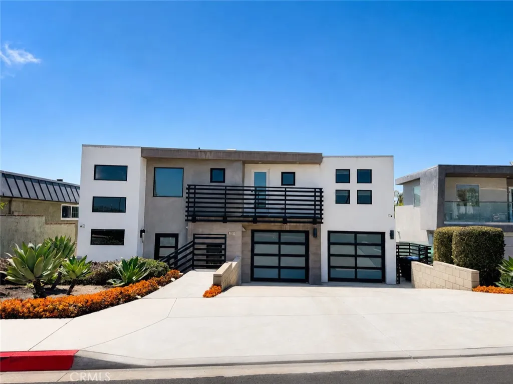 Front elevation highlighting the modern façade, clean lines, and landscaped entryway of the property.