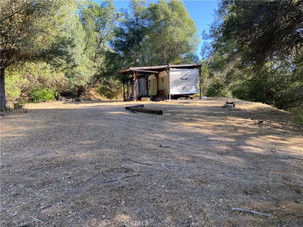 Mobile home on a very large building pad ready for your imagination to build your dream home!