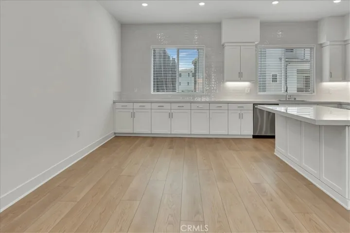 White glossy backsplash "jewelry of the kitchen" to the ceiling!  LOVELY!