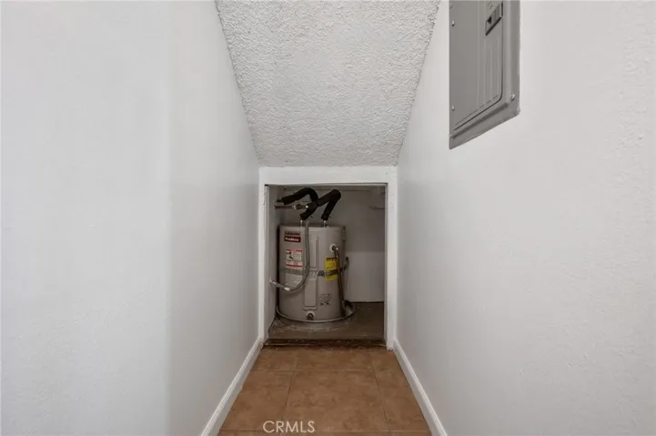 Storage Closet under stairs. Electric Water Heater
