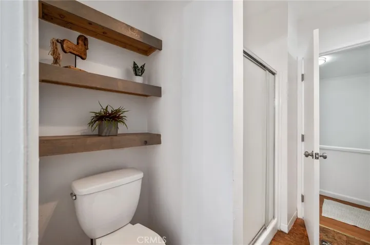 Shower connected to other bathroom with tub