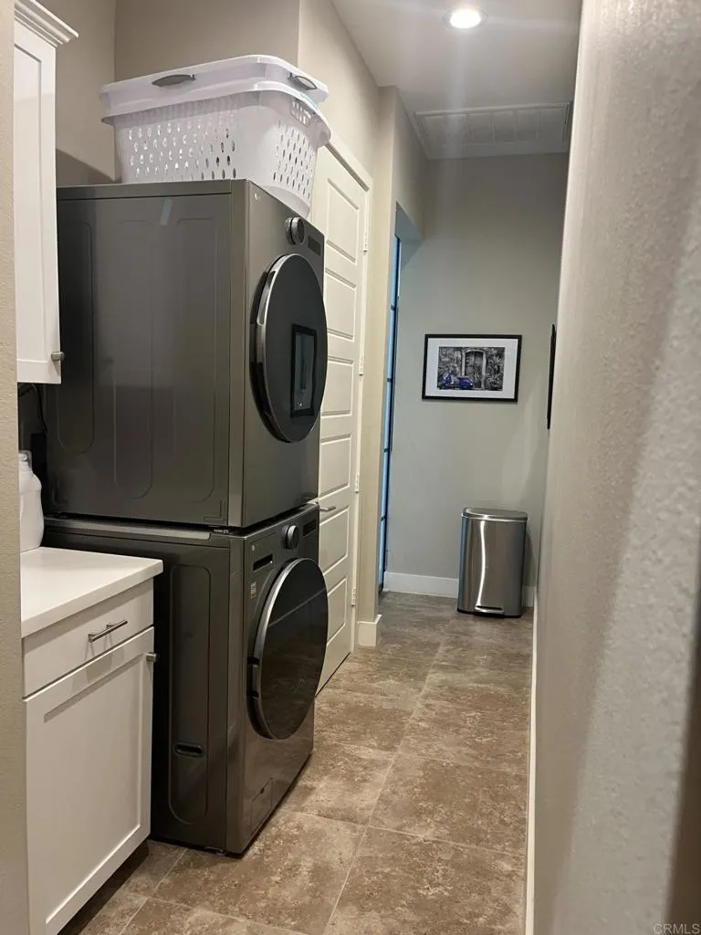 The laundry room is concealed behind elegant doors, hidden from the main living areas!