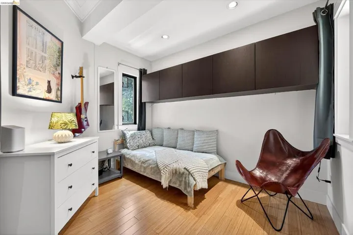 Compact room featuring wood-finish flooring and recessed lighting