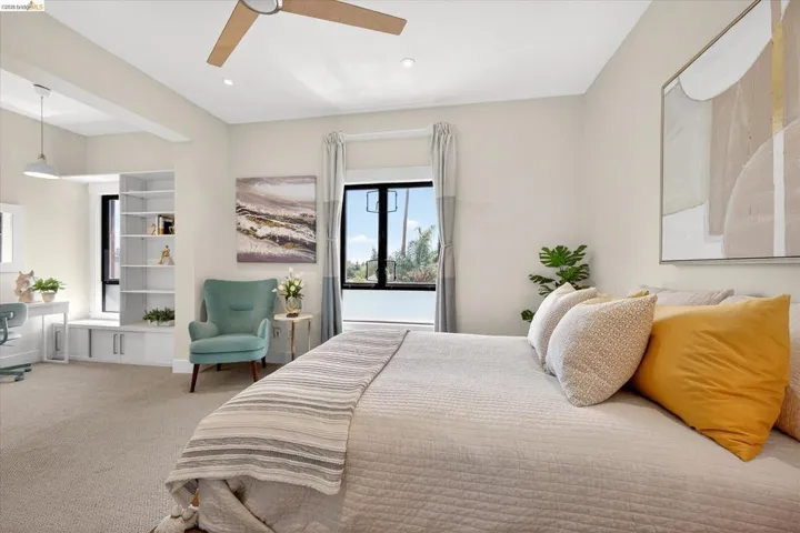 Spacious room with a ceiling fan, recessed lighting, and a built-in shelving unit