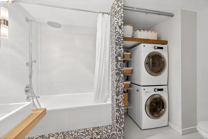 Contemporary bathroom featuring a white tile tub/shower combination with a rain shower head and handheld shower