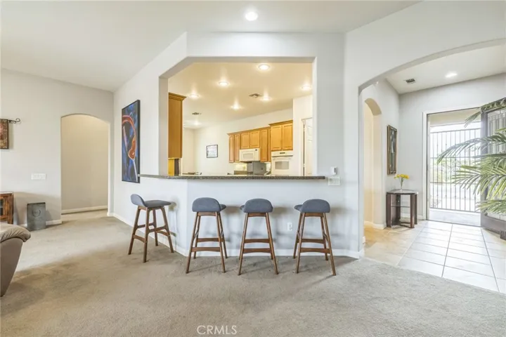 Bar in living room opens to the kitchen