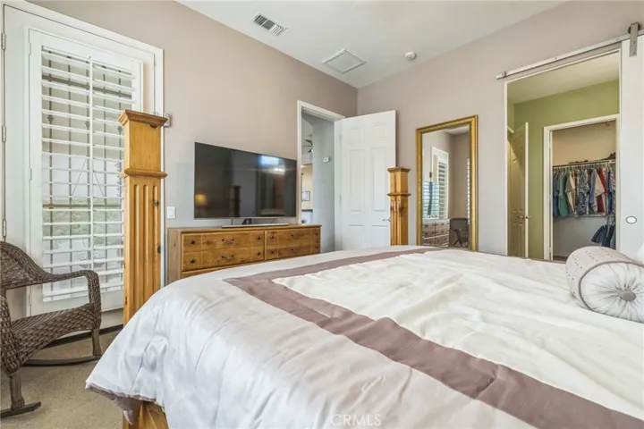 Primary bedroom has a door to the patio and pool.