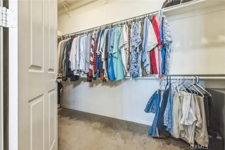 Massive walk in closet is just at the end of the bathroom.