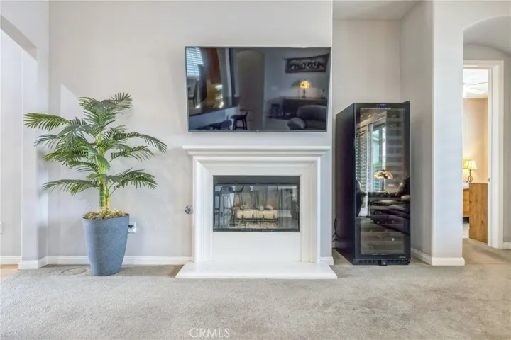 The fireplace is natural gas with a gas log. TV above the fireplace is included.