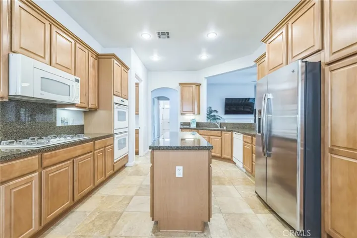What a great kitchen! There's a large island and plenty of counter space for the cook or cooks in the home.