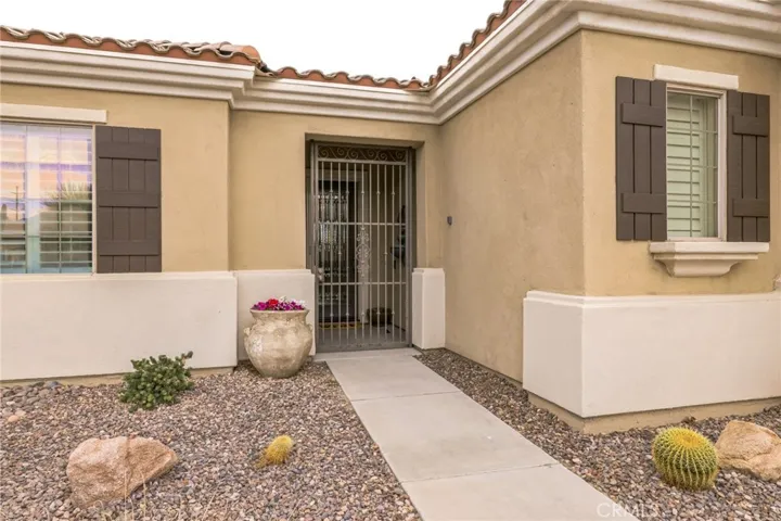 Pretty entry has a secure iron gate to enter the front porch.