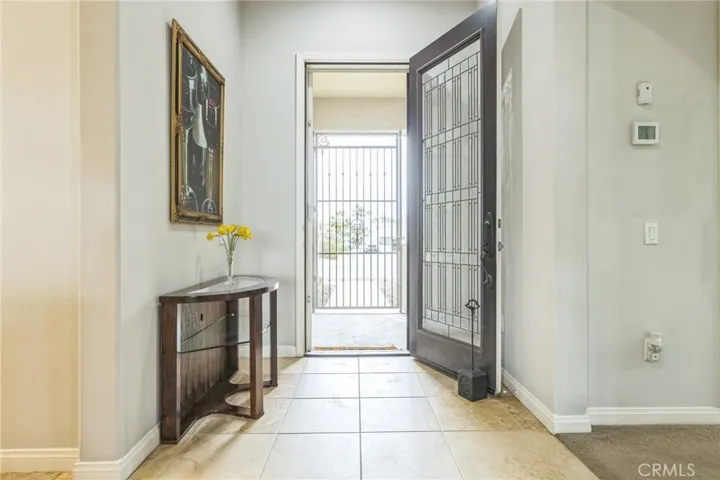 Entry hall has large ceramic tiles which flow through to the kitchen and laundry room.