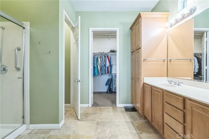 The Primary bathroom is like a spa! Dual sinks and large vanity. Large linen storage. Walk in shower with bench and a separate tub. Water closet with bidet.