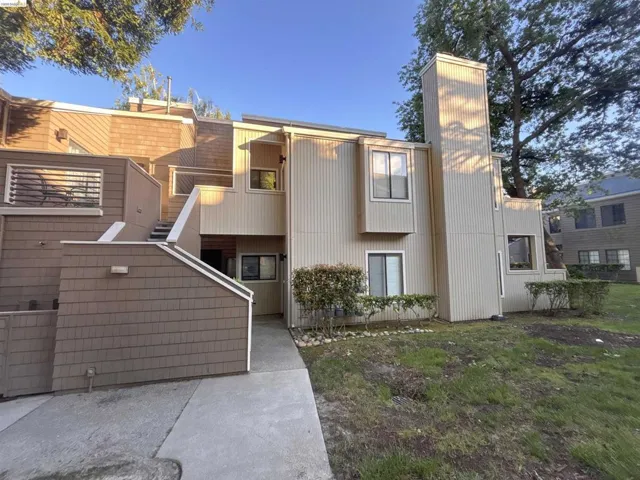 Multi-level exterior with shingle siding and vertical paneling
