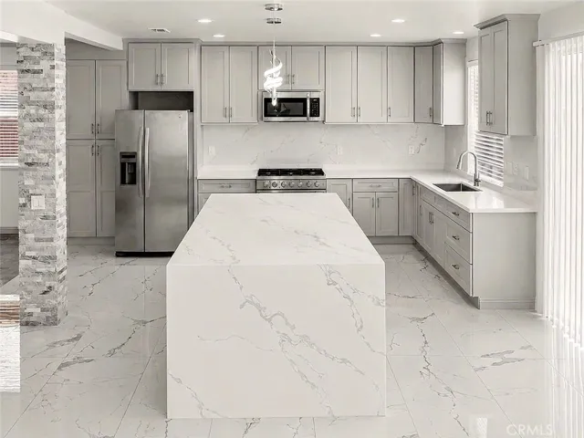 Kitchen with island quartz waterfall