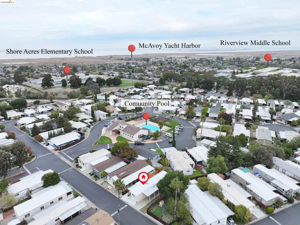 Aerial perspective of suburban area featuring a pool