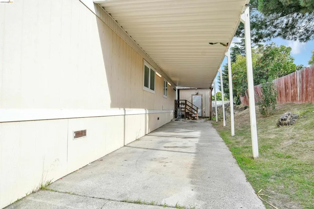 View of patio with a carport