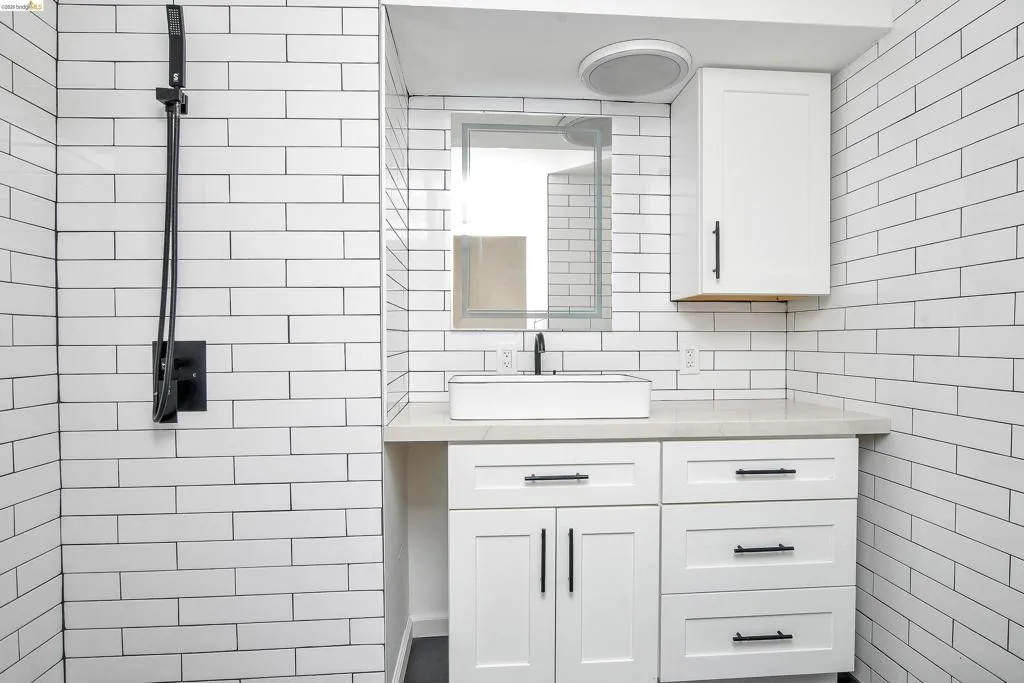 Bathroom featuring vanity and tile walls