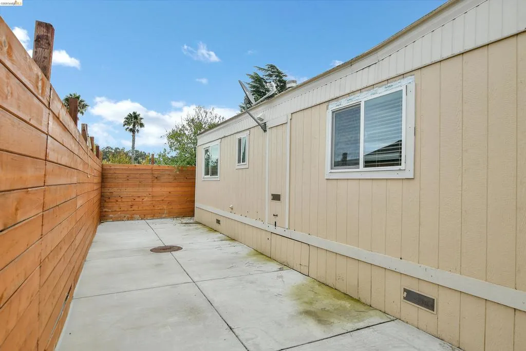Fenced backyard with a patio area