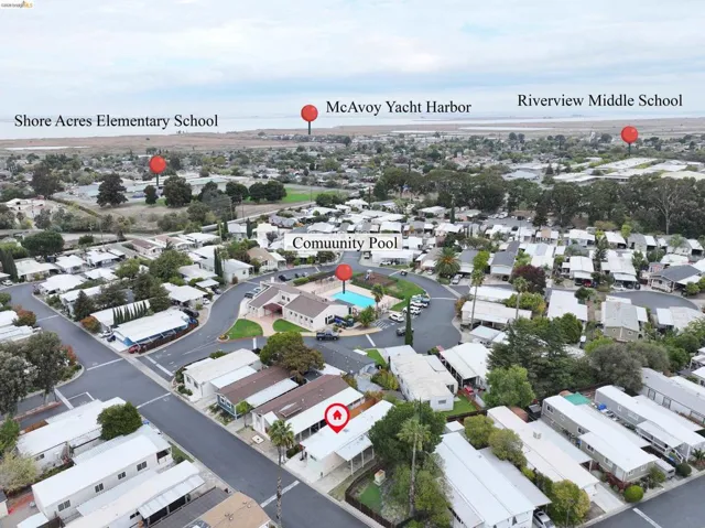 Aerial perspective of suburban area featuring a pool