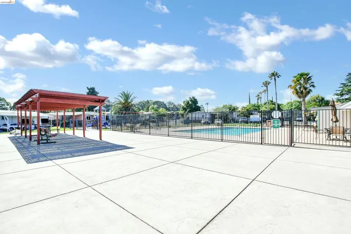 View of home's community featuring a pool and a patio area