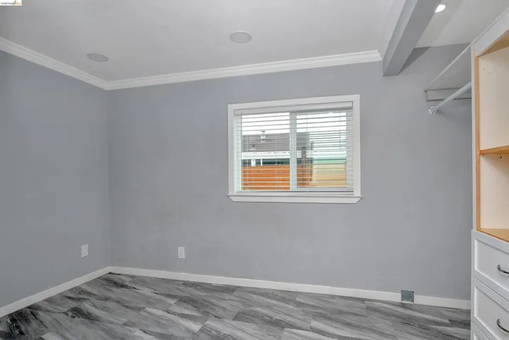 Unfurnished room with ornamental molding and baseboards