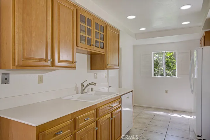 Kitchen has an added window bringing in sunlight.