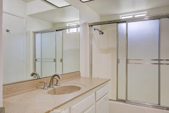 Tub-shower combo in left-side bathroom.