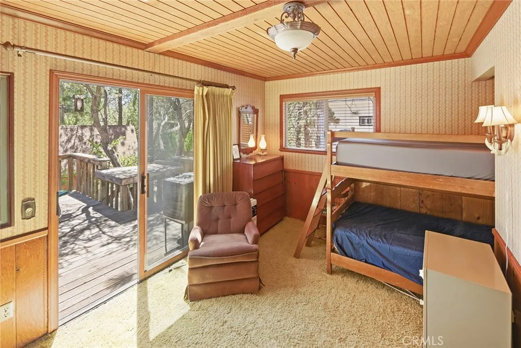 Large bedroom at back of house with direct access to backyard deck.