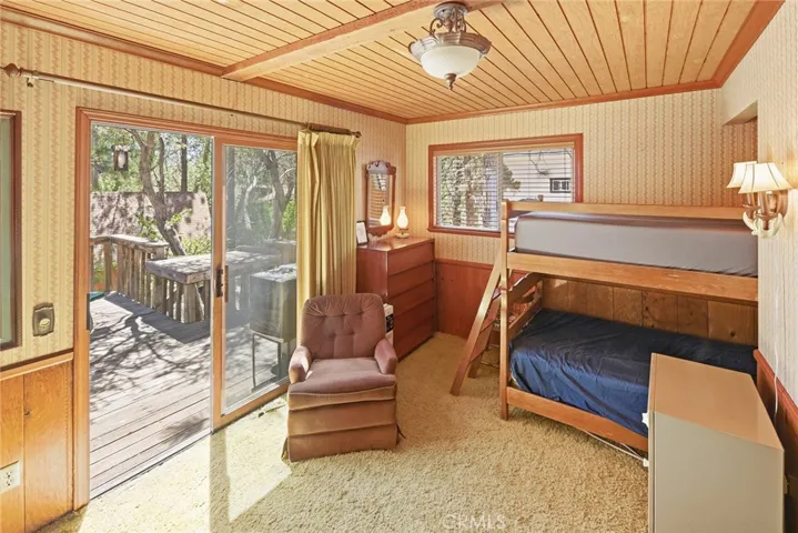 Large bedroom at back of house with direct access to backyard deck.